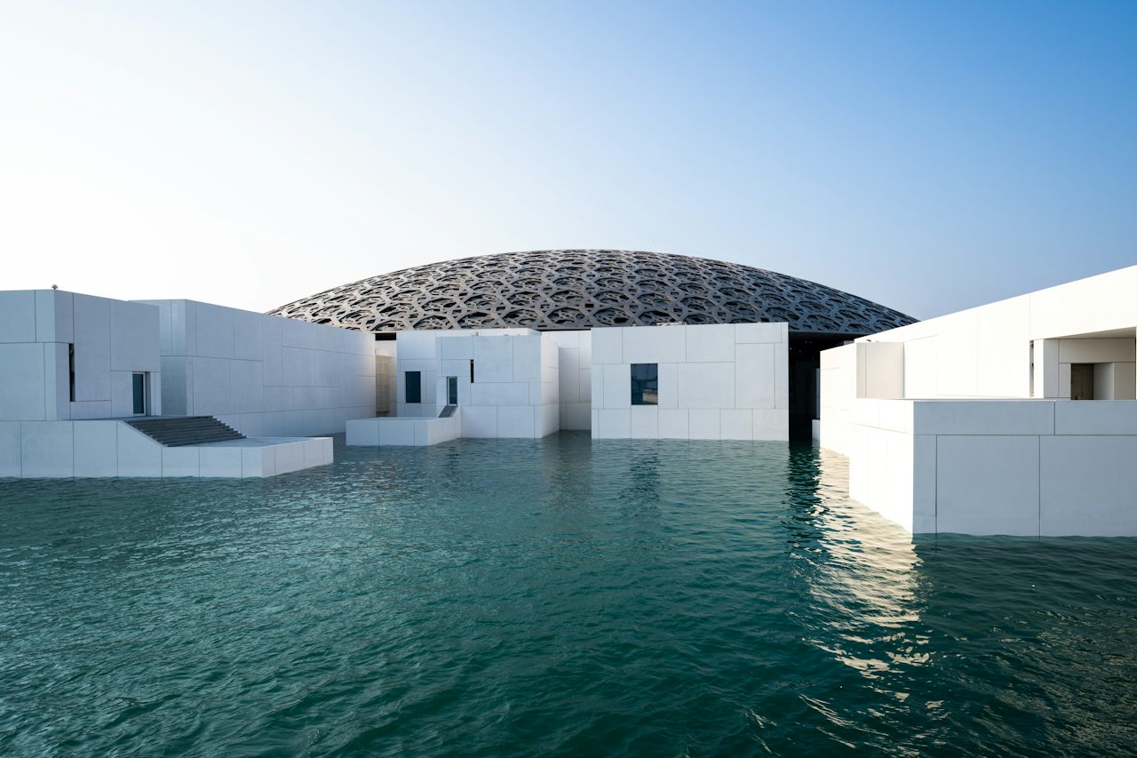 The domed roof of the Louvre Abu Dhabi above the water