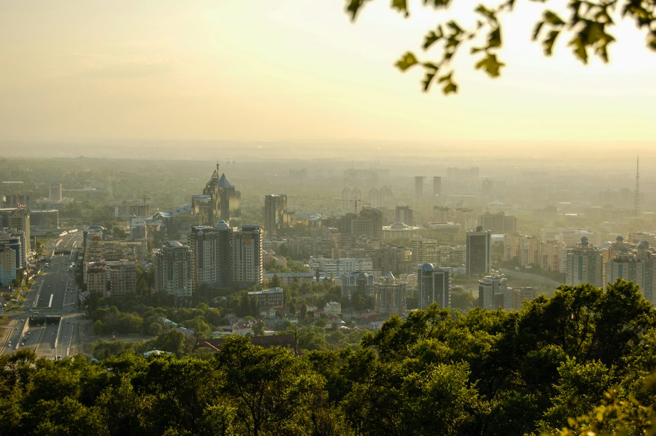 High-rise buildings among green trees in daylight, Almaty