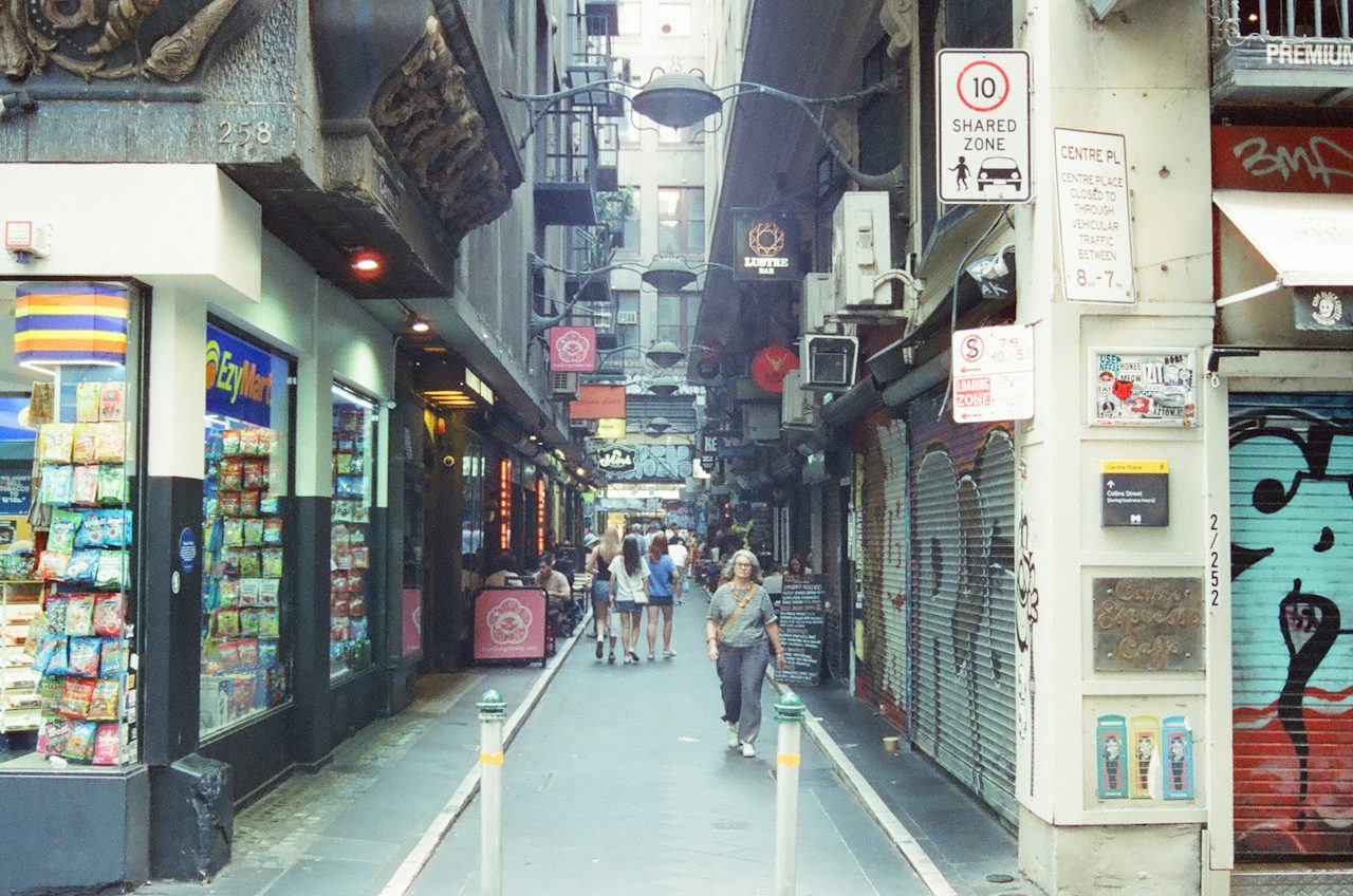 People walking a narrow laneway lined with shops, Melbourne